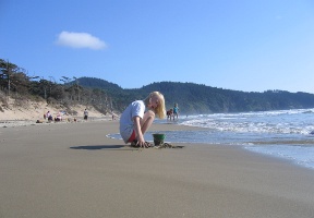 Johanna gathering some wet sand